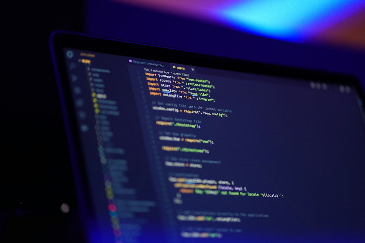 Laptop screen showing colourful source code